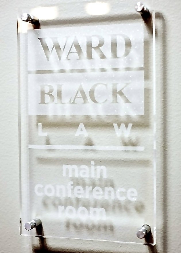 Frosted glass sign engraved Ward Black Law, main conference room