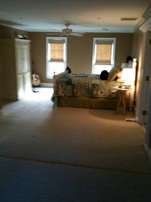 Before the remodel: the original primary bedroom with wall-to-wall carpet