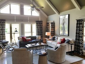 Vaulted family room with patterned drapery, a horse portrait and a mix of sofas and swivel chairs