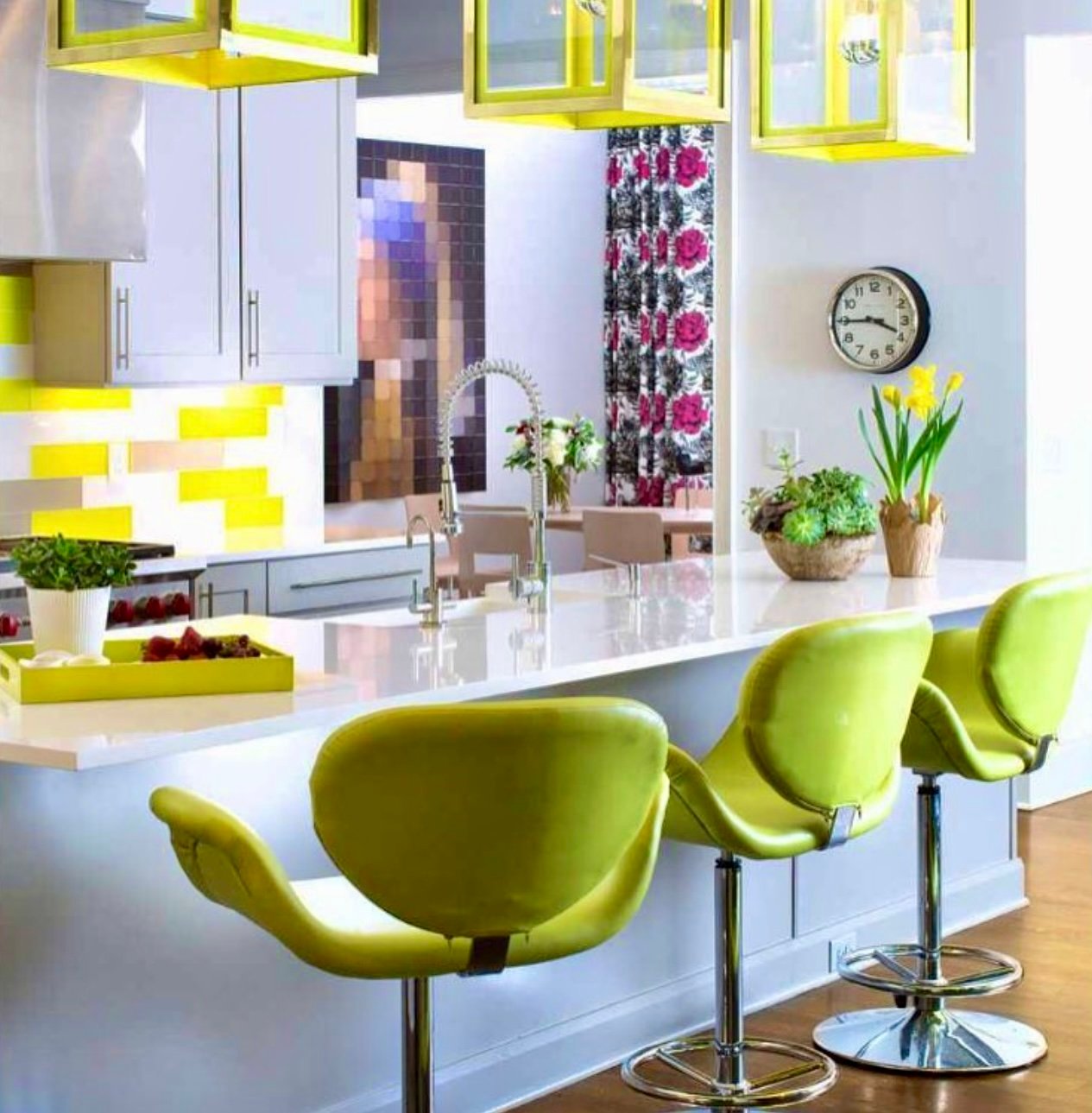Kitchen island with chartreuse tulip stools beneath lime-green lantern pendants