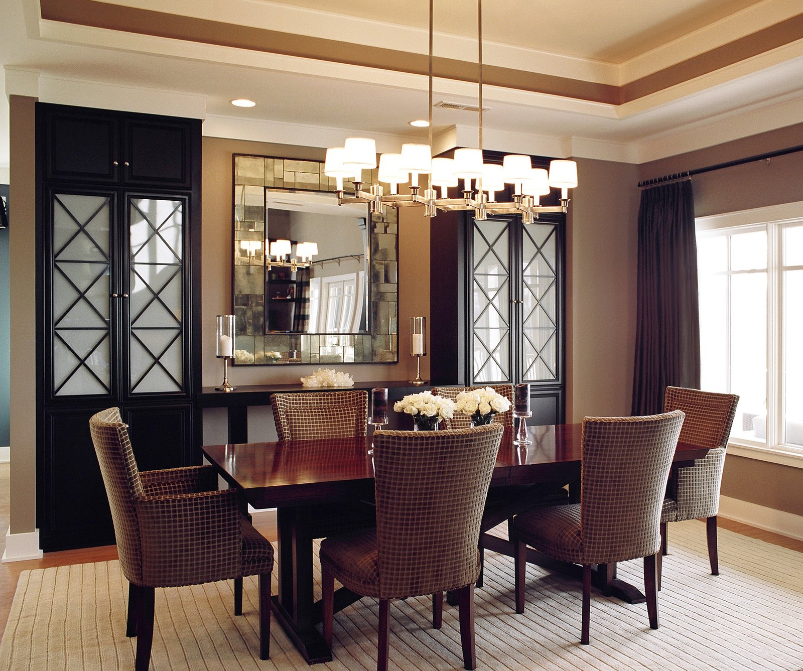 Tot Hill Farm dining room with a linear shaded chandelier, antiqued mirror and lattice-front cabinets