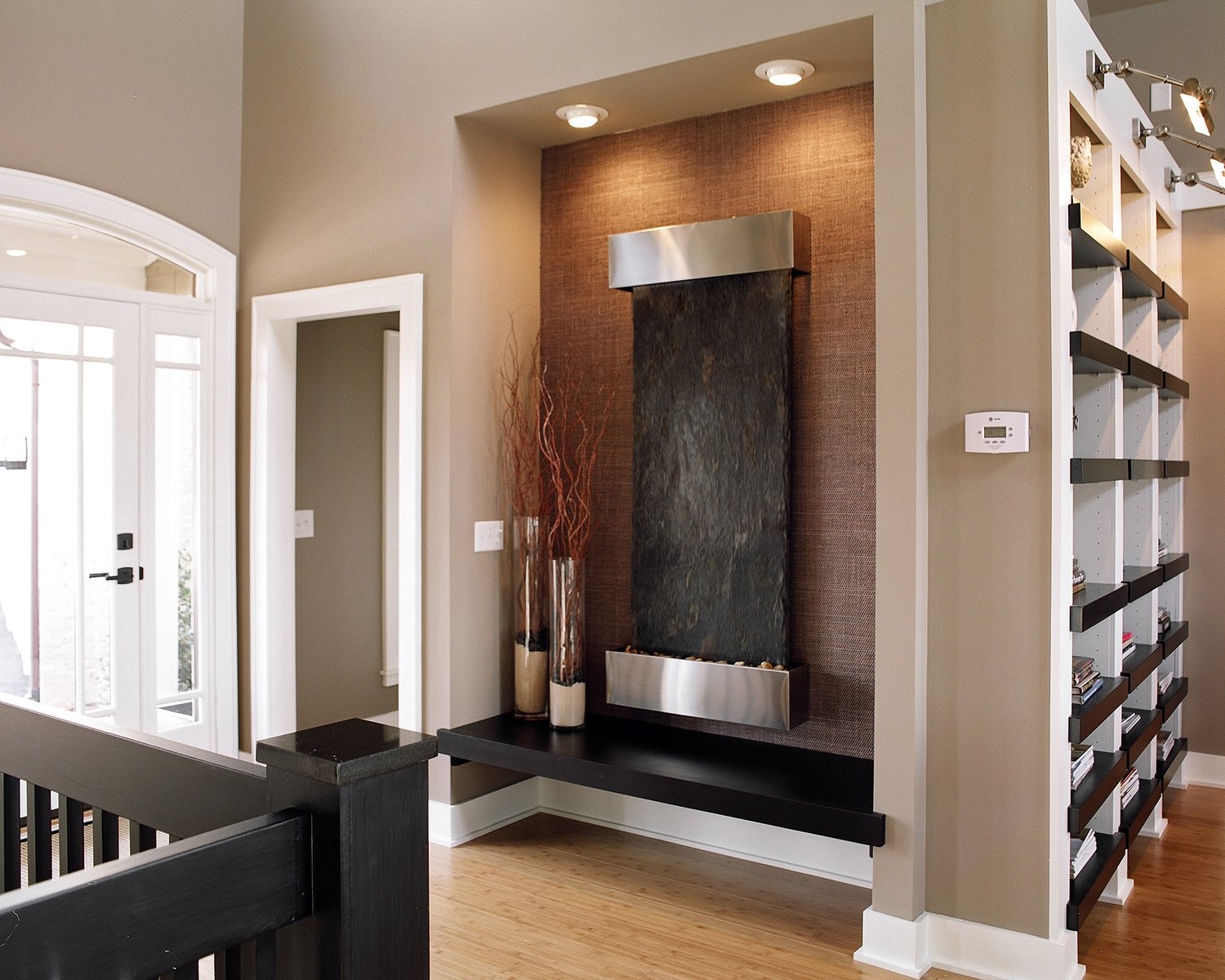 Tot Hill Farm entry with a slate water feature set into a warm wood niche